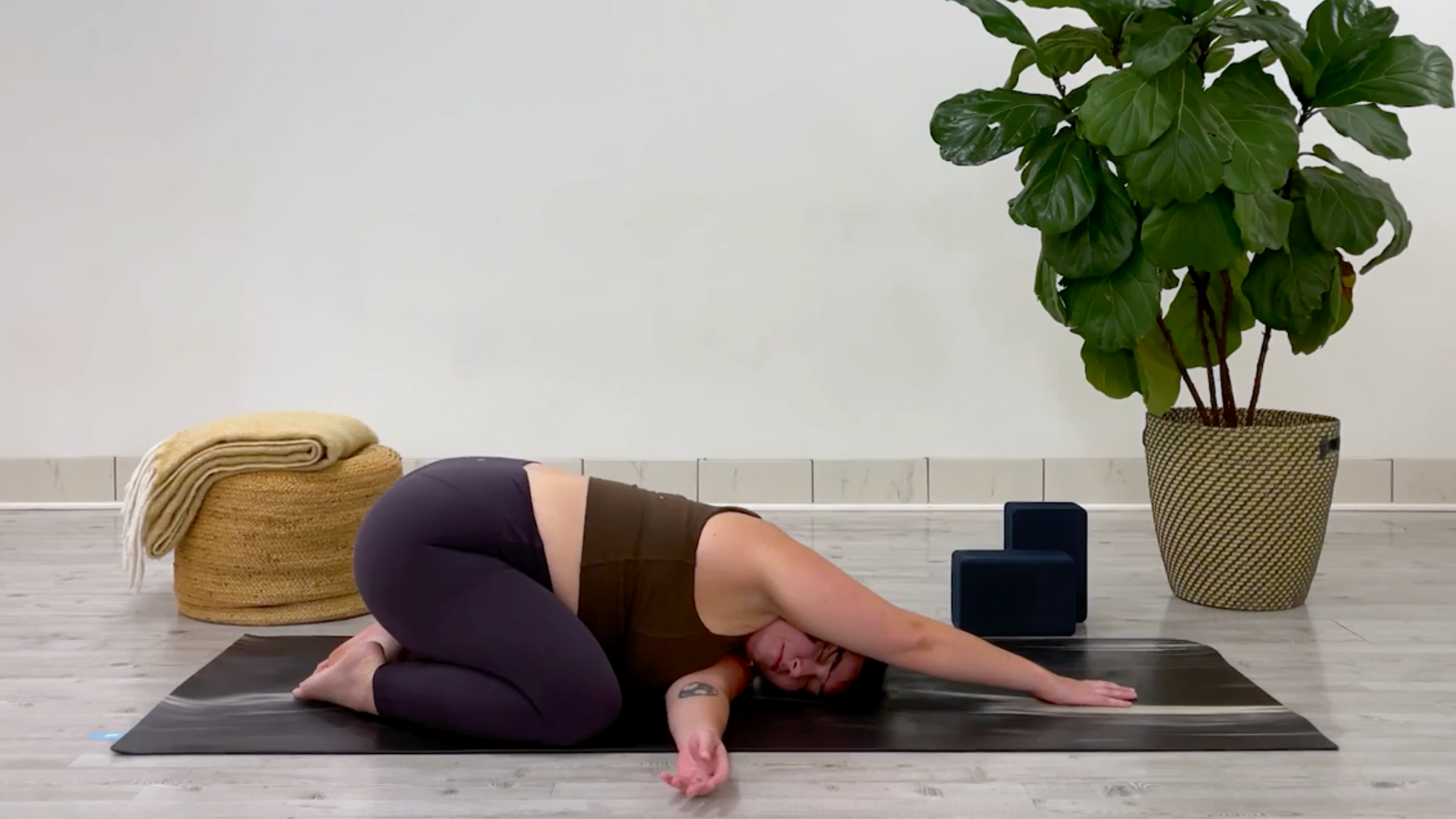 Yoga teacher Taylor Lorenz in Thread the Needle, part of her side stretch practice